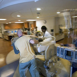 VCU hospital staff rush a patient down a hallway
