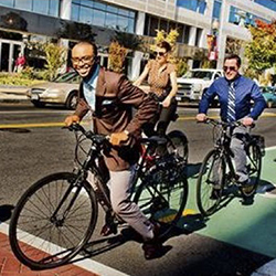 Bicyclists ride happily through downtown Richmond on a dedicated bike lane