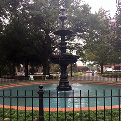 The central fountain of Monroe Park on a cloudy day shortly after the park was reopened